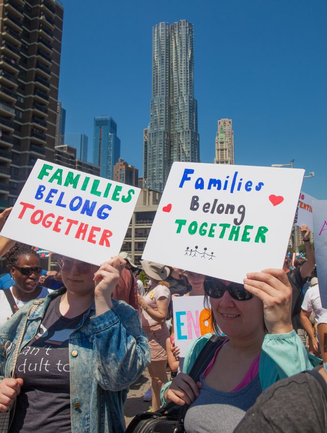 6/30/2018. New York City - March: “Families Belong Together.” Women with signs that read: "Families Belong Together". People crossing the Brooklyn Bridge in support of refugee families. People’s protectors are marching from Foley Square in Manhattan to Cadman Plaza in Brooklyn. Credit: Photo by Javier Soriano/LoveIsAmor.com