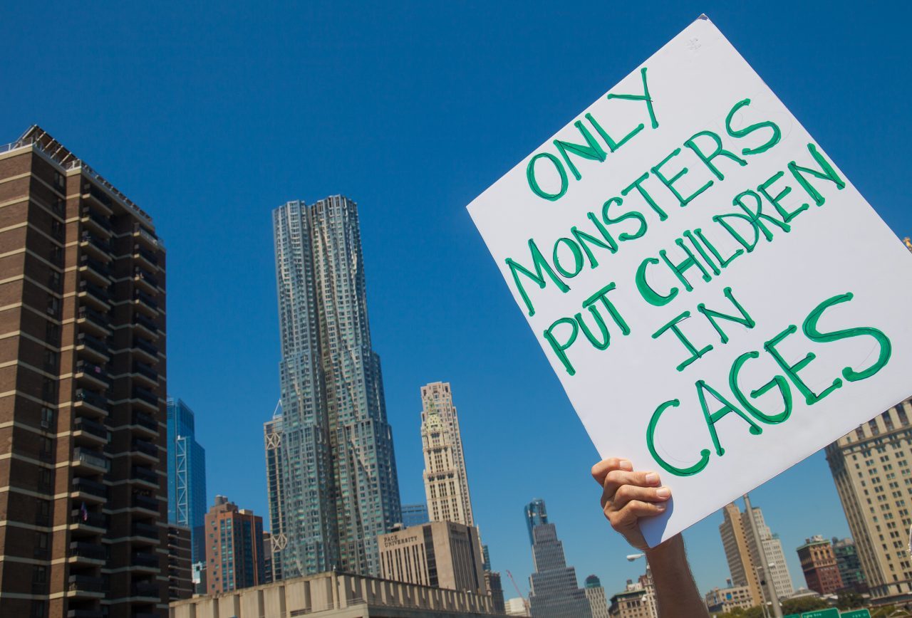 6/30/2018. New York City - March: “Families Belong Together.” A person with a sign that reads: "Only monsters put children in cages." People crossing the Brooklyn Bridge in support of refugee families. People’s protectors are marching from Foley Square in Manhattan to Cadman Plaza in Brooklyn. Credit: Photo by Javier Soriano/LoveIsAmor.com