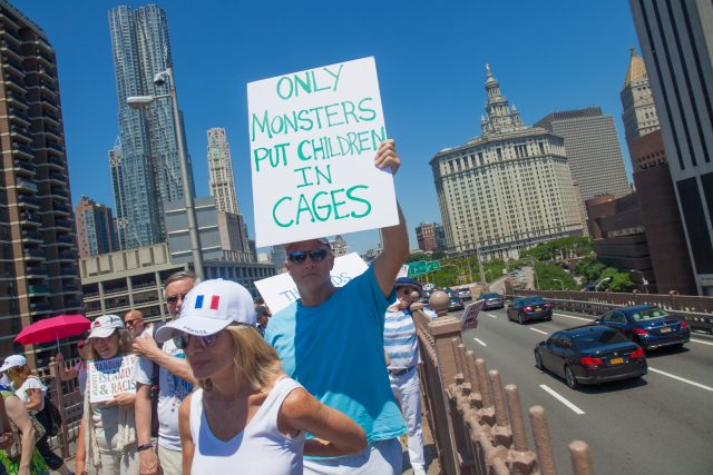 6/30/2018. New York City - March: “Families Belong Together.” A man with a sign that reads: "Only monsters put children in cages." People crossing the Brooklyn Bridge in support of refugee families. People’s protectors are marching from Foley Square in Manhattan to Cadman Plaza in Brooklyn. Credit: Photo by Javier Soriano/LoveIsAmor.com
