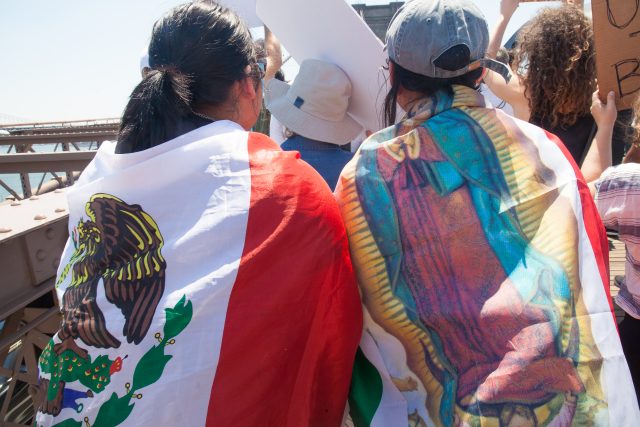 6/30/2018. New York City - March: “Families Belong Together.” Women with Mexican flags and the Virgin of Guadalupe. People crossing the Brooklyn Bridge in support of refugee families. People’s protectors are marching from Foley Square in Manhattan to Cadman Plaza in Brooklyn. Credit: Photo by Javier Soriano/LoveIsAmor.com