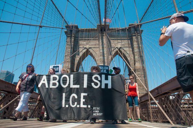 6/30/2018. New York City - March: “Families Belong Together.” People with a banner that reads: "ABOLISH I.C.E. Rise and resist." People crossing the Brooklyn Bridge in support of refugee families. People’s protectors are marching from Foley Square in Manhattan to Cadman Plaza in Brooklyn. Credit: Photo by Javier Soriano/LoveIsAmor.com