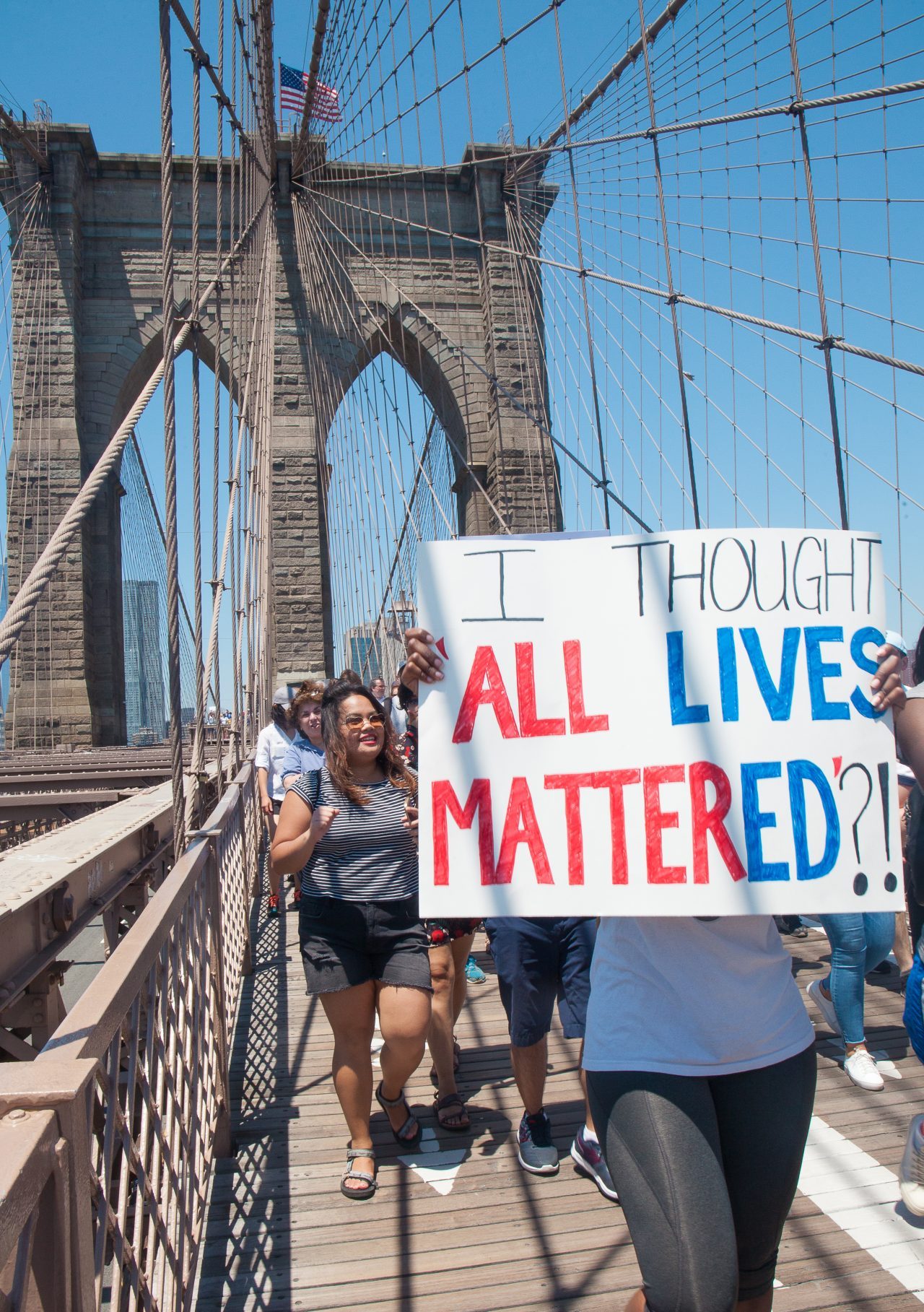 6/30/2018. New York City - March: “Families Belong Together.” Woman with a sign that reads: "I thought ALL LIVES MATTERED?!" People crossing the Brooklyn Bridge in support of refugee families. People’s protectors are marching from Foley Square in Manhattan to Cadman Plaza in Brooklyn. Credit: Photo by Javier Soriano/LoveIsAmor.com