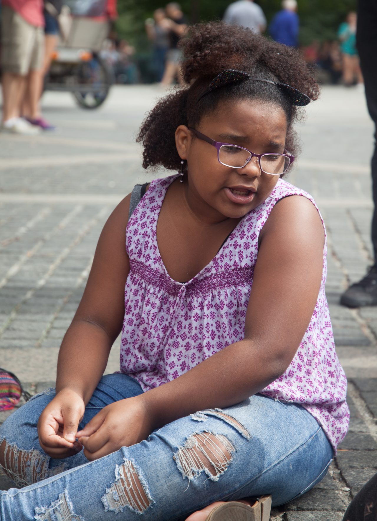Sunday, October 7th, 2018. Columbus Circle. West 59th Street and Central Park West. Manhattan, New York City - Girl reading at the 11th Annual Indigenous Day of Remembrance. Credit: Photo by LoveIsAmor.com
