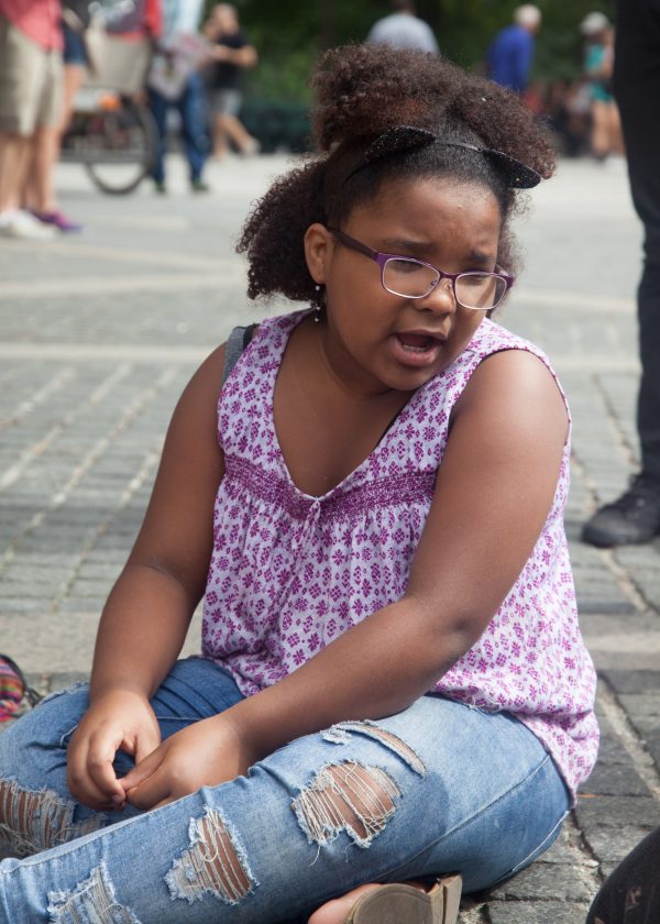 Sunday, October 7th, 2018. Columbus Circle. West 59th Street and Central Park West. Manhattan, New York City - Girl reading at the 11th Annual Indigenous Day of Remembrance. Credit: Photo by LoveIsAmor.com