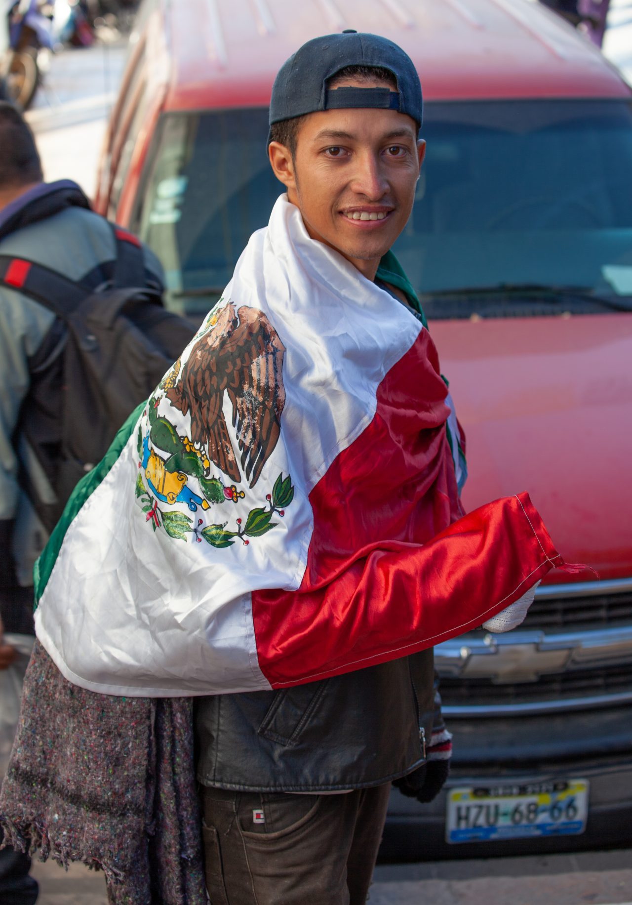 Tlaquepaque, Guadalajara. Jalisco, Mexico. Monday, November 19th, 2018. Refugee fleeing violence and extreme poverty in Central America at "El Refugio. Casa del Migrante." This immigrant is from Honduras and he is part of the second caravan. He has the Mexican flag. He is grateful with Mexico. Credit: Photo by LoveIsAmor.com