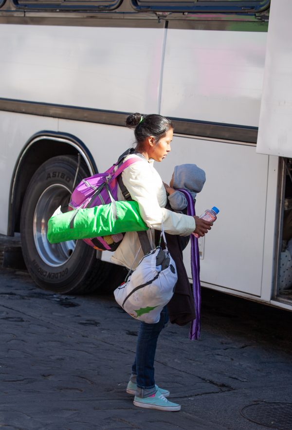 Tlaquepaque, Guadalajara. Jalisco, Mexico. Monday, November 19th, 2018. A refugee mother and her baby boarding a bus to Sinaloa. Hundreds of refugees fleeing violence and extreme poverty in Central America have been staying at "El Refugio. Casa del Migrante" for one or two days. This immigrant family is part of the second caravan. They want to apply for asylum in the United States of America. Credit: Photo by LoveIsAmor.com