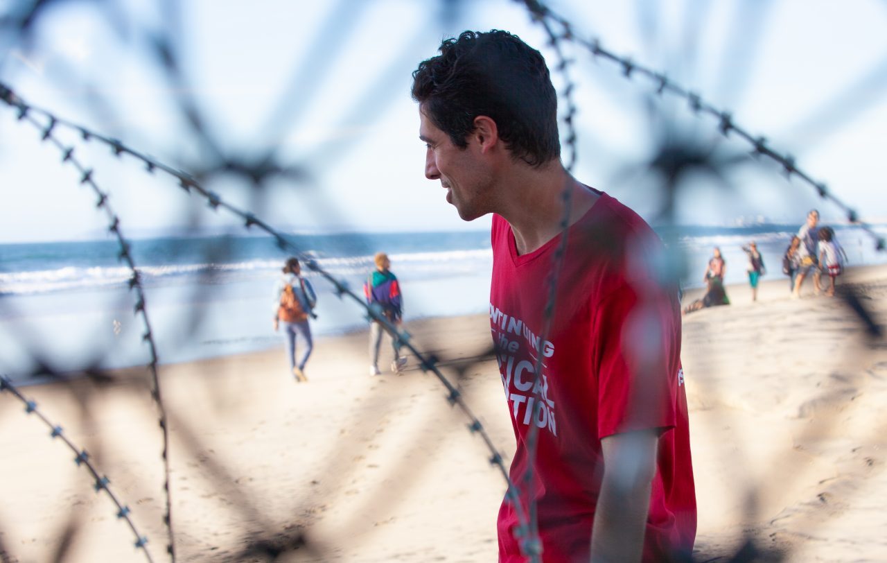 Tijuana, Baja California. Mexico. Sunday, November 25th, 2018 - Members of the Democratic Socialists Of America (DSA) giving water to immigrants from Centro America at the Mexico - US border. Credit: Photo by LoveIsAmor.com