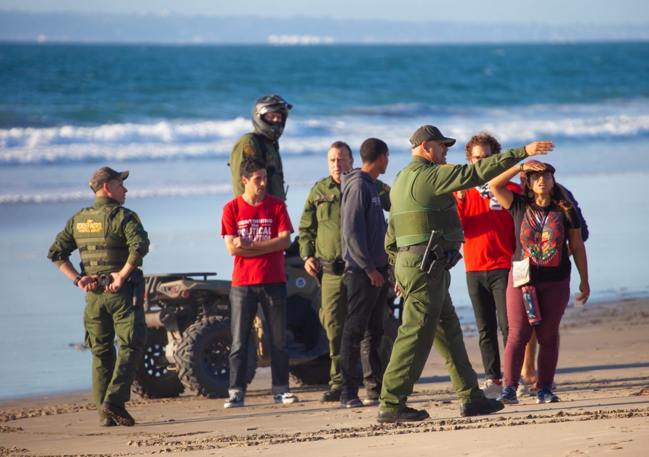 Tijuana, Baja California. Mexico. Sunday, November 25th, 2018 - Members of the Democratic Socialists Of America (DSA) gave water to immigrants from Centro America at the Mexico - US border. US border agents ordered them to move away from the fence. Credit: Photo by LoveIsAmor.com