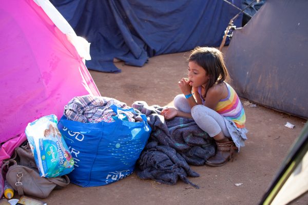 Tijuana, Baja California. Mexico. Monday, November 26th, 2018. A little girl refugee at Unidad Deportiva Benito Juárez (an improvised shelter for the caravans of immigrants). Refugees are fleeing violence and extreme poverty in their countries in Central America. They want to apply for asylum in the United States of America. Credit: Photo by LoveIsAmor.com