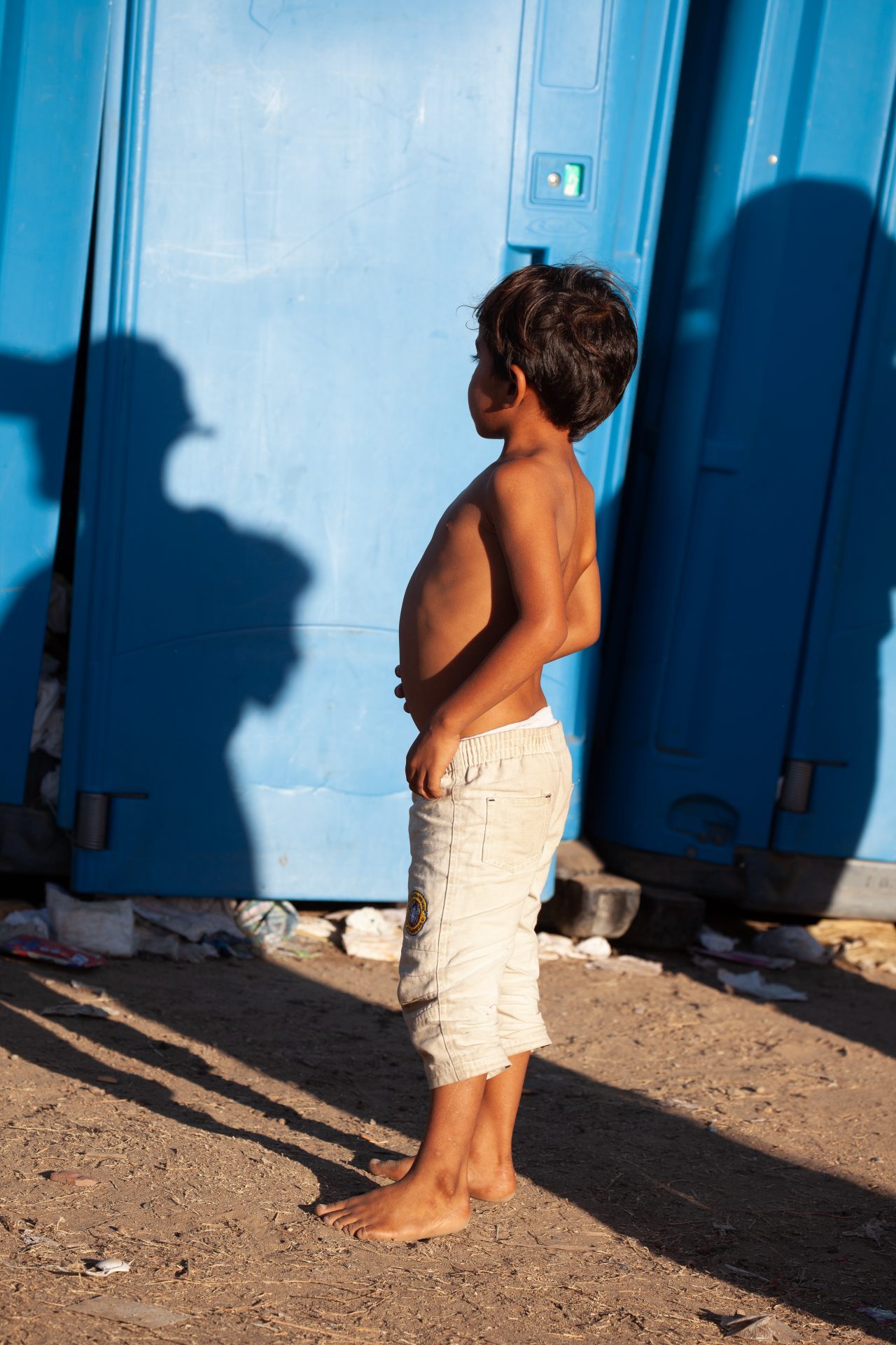 Tijuana, Baja California. Mexico. Monday, November 26th, 2018. A refugee boy looking for a bathroom at Unidad Deportiva Benito Juárez (an improvised shelter for the caravans of immigrants). Bathrooms are located inside the makeshift shelter. Bathrooms smell really bad and are already at their maximum capacity. Authorities need to change the portable toilets. This is not healthy for refugees, volunteers, media and others. Immigrants are fleeing violence and extreme poverty in their countries in Central America. They want to apply for asylum in the United States of America. Credit: Photo by LoveIsAmor.com