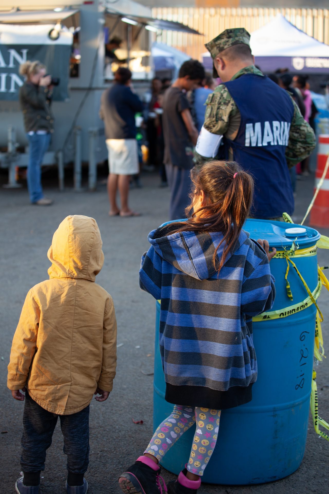 Tijuana, Baja California. Mexico. Monday, November 26th, 2018. Children and their parents waiting in line to get food. Mexican Marina is giving food to refugees staying at Unidad Deportiva Benito Juárez (an improvised shelter for the caravans of immigrants). Refugees are fleeing violence and extreme poverty in their countries in Central America. They want to apply for asylum in the United States of America. Credit: Photo by LoveIsAmor.com
