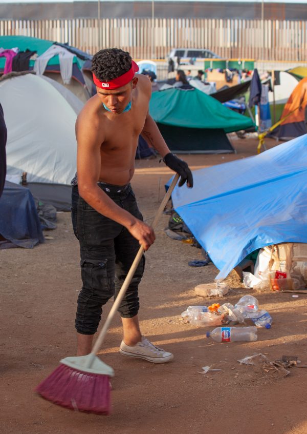 Tijuana, Baja California. Mexico. Tuesday, November 27th, 2018. A refugee man cleaning. He is staying at Unidad Deportiva Benito Juárez (an improvised shelter for the caravans of immigrants). Refugees are fleeing violence in their countries in Central America. They want to apply for asylum in the United States of America. Credit: Photo by LoveIsAmor.com