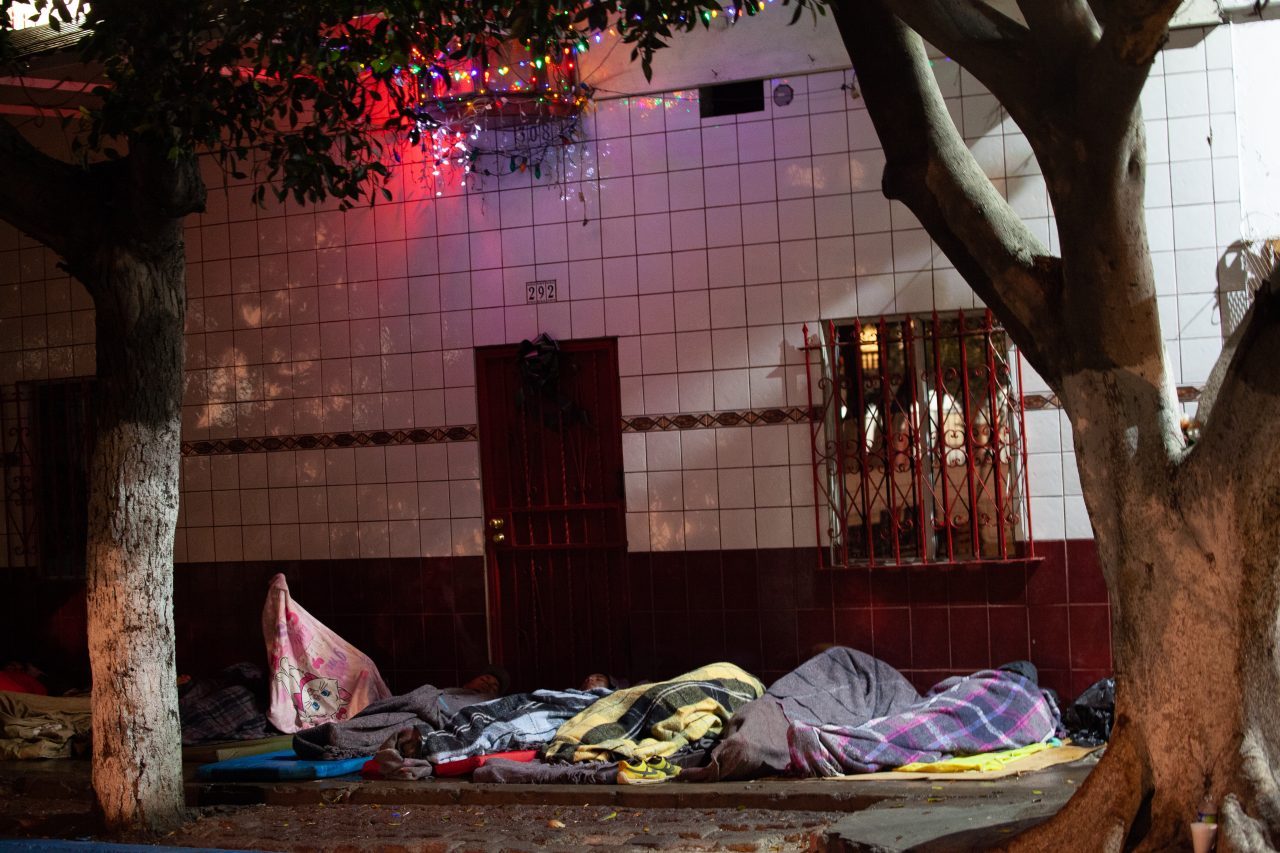 Tijuana, Baja California. Mexico. Thursday, November 29th, 2018. Refugees sleeping outside Unidad Deportiva Benito Juárez (an improvised shelter for the caravans of immigrants). It was raining last night. They do not have a tent. Refugees are fleeing violence in their countries in Central America. They want to apply for asylum in the United States of America. Credit: Photo by LoveIsAmor.com