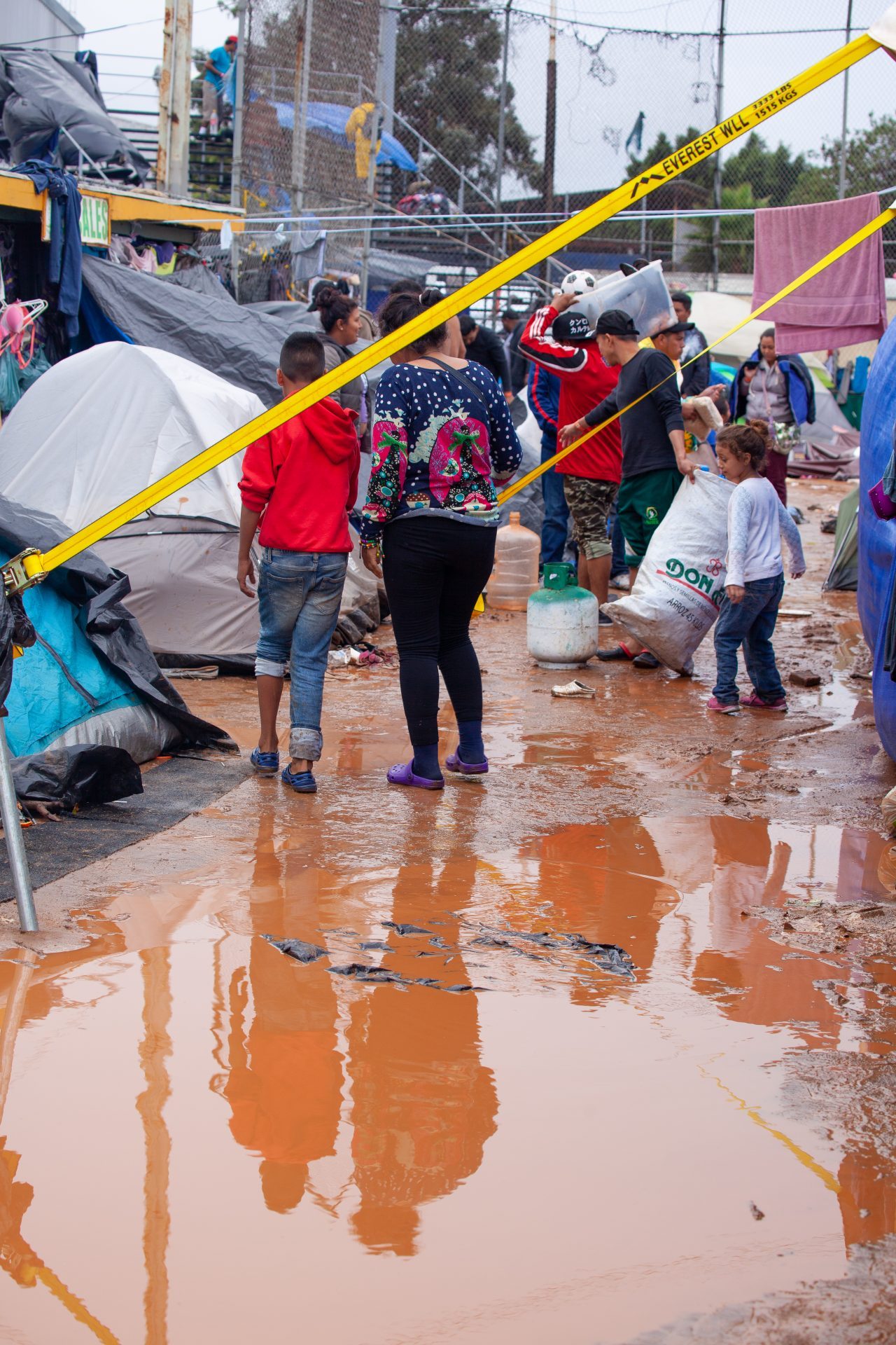 Tijuana, Baja California. Mexico. Thursday, November 29th, 2018. It was raining last night and it was raining all day today. The Mexican government needs to find a shelter for the refugees where they can be protected from the rain and cold. Refugees are staying at Unidad Deportiva Benito Juárez (an improvised shelter for the caravans of immigrants). Refugees are fleeing violence in their countries in Central America. They want to apply for asylum in the United States of America. They were told they have to wait more than a month to apply for asylum. Credit: Photo by LoveIsAmor.com