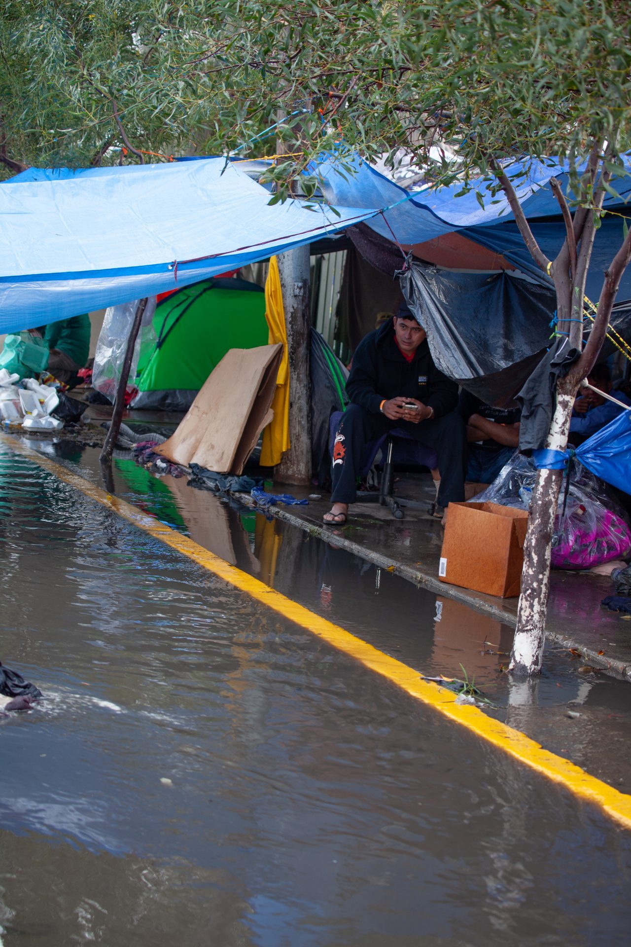 Tijuana, Baja California. Mexico. Thursday, November 29th, 2018. It was raining last night and it was raining all day today. The Mexican government needs to find a shelter for the refugees where they can be protected from the rain and cold. Refugees are staying at Unidad Deportiva Benito Juárez (an improvised shelter for the caravans of immigrants). Refugees are fleeing violence in their countries in Central America. They want to apply for asylum in the United States of America. They were told they have to wait more than a month to apply for asylum. Credit: Photo by LoveIsAmor.com