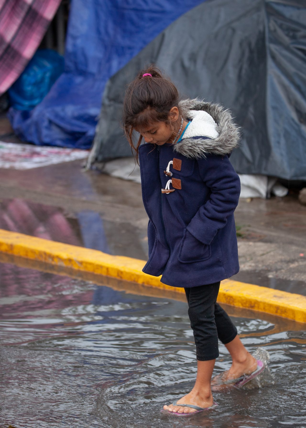 Tijuana, Baja California. Mexico. Thursday, November 29th, 2018. It was raining last night and it was raining all day today. The Mexican government needs to find a shelter for the refugees where they can be protected from the rain and cold. Refugees are staying at Unidad Deportiva Benito Juárez (an improvised shelter for the caravans of immigrants). Refugees are fleeing violence in their countries in Central America. They want to apply for asylum in the United States of America. They were told they have to wait more than a month to apply for asylum. Credit: Photo by LoveIsAmor.com