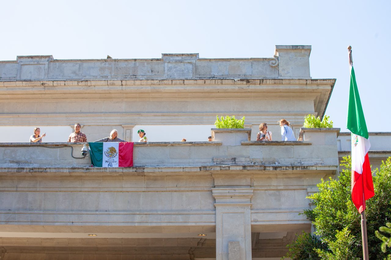 Mexico City, Mexico. Saturday, December 1, 2018. Woman with the Mexican flag at the house where Mexican Presidents used to live. The flag reads: "Viva México sin PRI." The "Official Residence of Los Pinos" was the residence of the Mexican presidents. As of Saturday, December 1, 2018, it will be known as the "Los Pinos Cultural Complex." The official website says: "Los Pinos will be a completely open space for all Mexicans." Today was the inauguration of Mexican President Andrés Manuel López Obrador. People came to Los Pinos to celebrate this historic day. Credit: Photo by LoveIsAmor.com