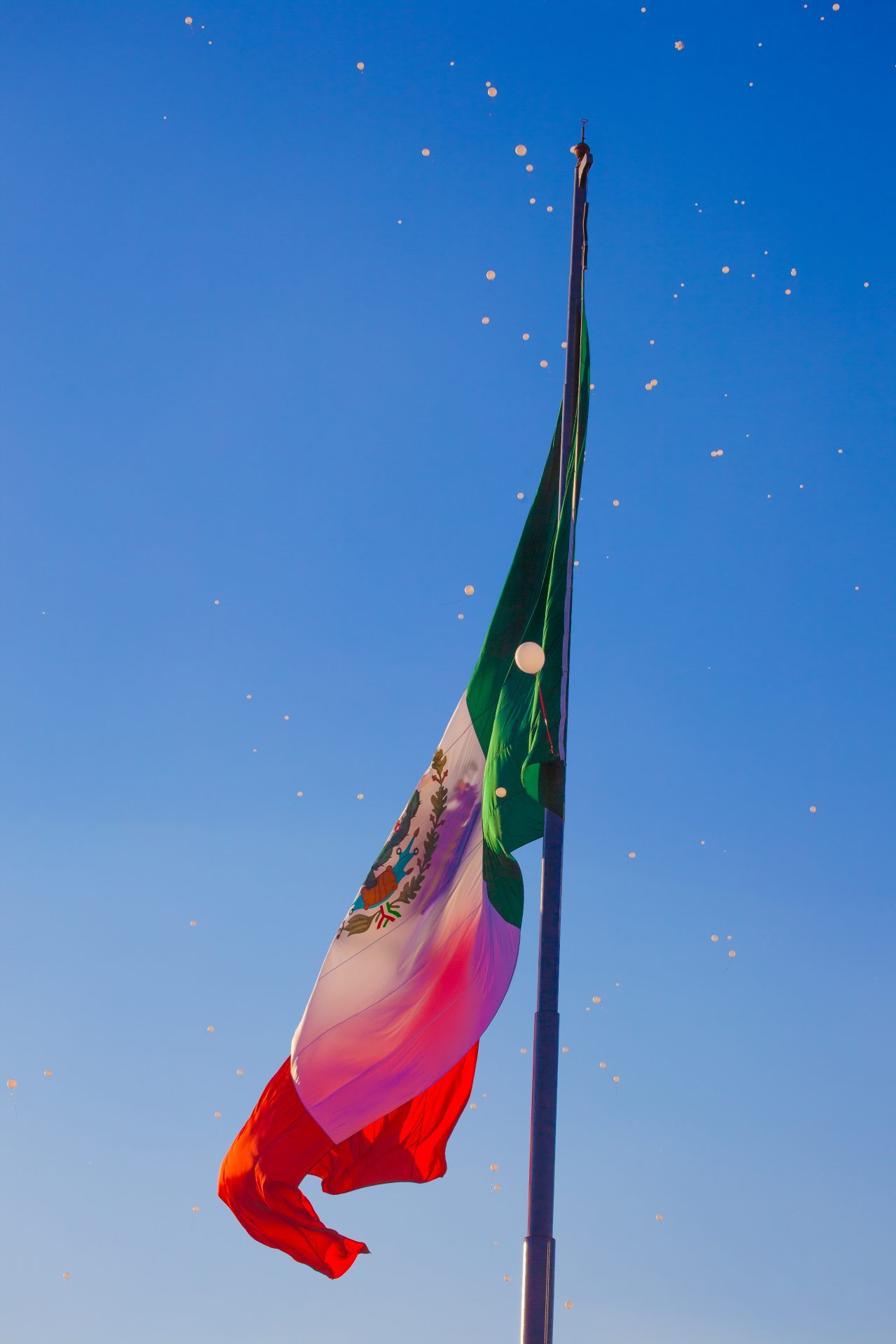 Mexico City, Mexico. Saturday, December 1, 2018. White balloons and the Mexican flag on the Zocalo in Mexico City. Today was the inauguration of Mexican President Andrés Manuel López Obrador. People came to celebrate this historic day. López Obrador – known as AMLO - said, “We are going to govern for everyone, but we are going to give preference to the most impoverished and vulnerable. For the good of all, the poor come first.” Andrés Manuel received a spiritual cleansing by indigenous women and men as part of the celebrations. Credit: Photo by LoveIsAmor.com