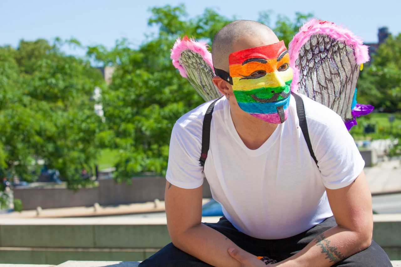 Sunday, June 23rd, 2019. Bronx, New York City - Today was the 1 Bronx World Pride Rally, March and Festival. Today people celebrated Bronx World Pride, Pride Month and the 50th anniversary of the Stonewall Rebellion. This Latino man was one of the attendees who came to celebrate Bronx World Pride, Pride Month and the 50th anniversary of the Stonewall rebellion. He was wearing a rainbow mask and a rainbow wings. Credit: Photo by LoveIsAmor.com