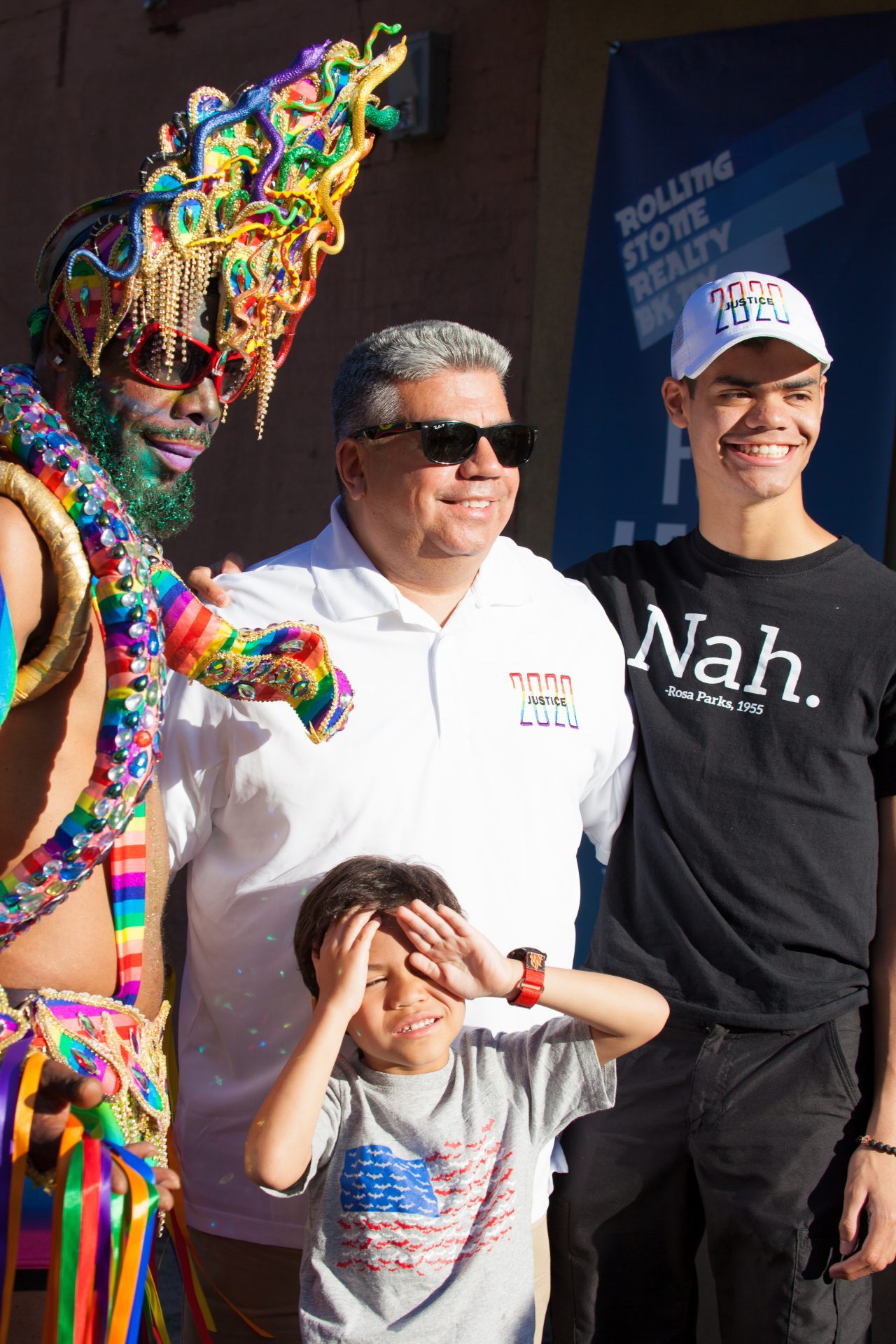 Saturday, June 8th, 2019. Brooklyn, New York City - Brooklyn District Attorney Eric Gonzalez, his sons and a Black man wearing a beautiful costume at the Brooklyn Pride Parade/March. This year, Brooklyn celebrated the 23rd Annual Brooklyn Pride Parade/March. Brooklyn Pride was ranked within the top 10 of the 20 best places in the US to celebrate pride by matadornetwork.com. This year is the 50th anniversary of the Stonewall revolution. Credit: Photo by LoveIsAmor.com